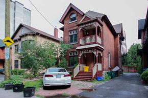 Ottawa apartment for rent - A car is parked in front of a house.