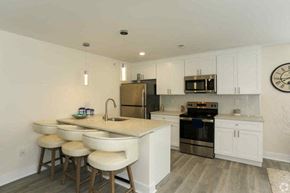 Philadelphia apartment for rent - a kitchen with a center island and bar stools
