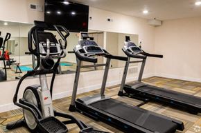 Philadelphia apartment for rent - a row of treadmills in a gym with a tv on the wall