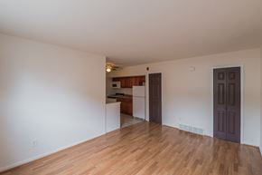 Philadelphia apartment for rent - the living room and kitchen of an empty apartment with wood flooring