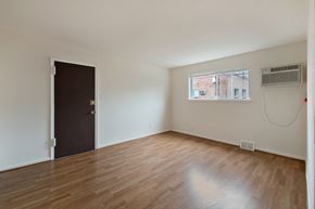 Philadelphia apartment for rent - an empty living room with wood floors and a window