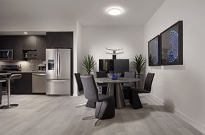 Chamblee apartment for rent - A modern kitchen with a dining table set for four.