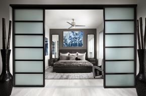 Chamblee apartment for rent - A modern bedroom with a large bed and a ceiling fan.
