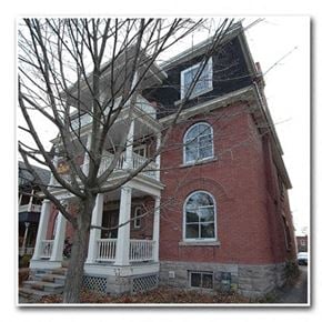 Ottawa apartment for rent - a red brick house with a tree in front of it