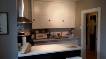 Ottawa apartment for rent - a kitchen with white cabinets and a white counter top