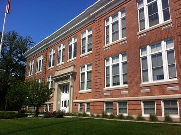 Indianapolis apartment for rent - a large brick building with a flag in front of it