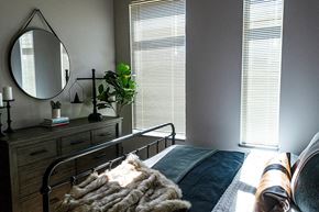 Ames apartment for rent - a bedroom with a bed and a mirror