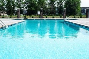 Ames apartment for rent - a large pool of water next to a fence
