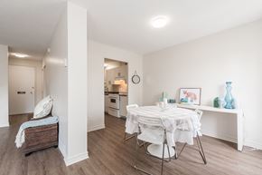 Ottawa apartment for rent - a dining room with a white table and chairs