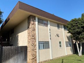 Long Beach apartment for rent - a building with a fence in front of it