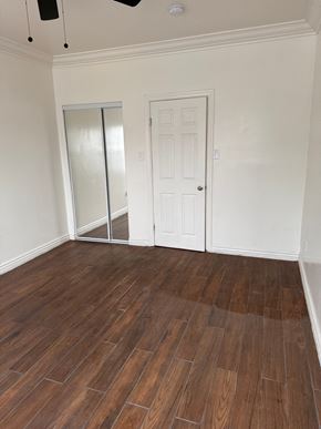 Los Angeles apartment for rent - A room with a wooden floor and white walls.