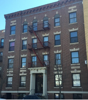Brooklyn apartment for rent - A red brick building with a fire escape on the side.