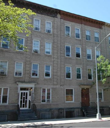 Brooklyn apartment for rent - a brick building with a tree in front of it