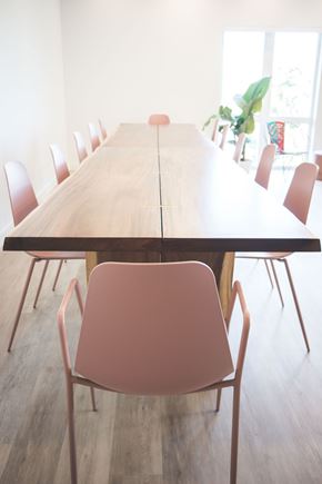 Sacramento apartment for rent - a large wooden table with pink chairs in a dining room
