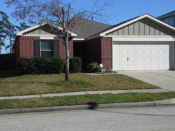 Humble house for rent - a house with a white garage door in front of it