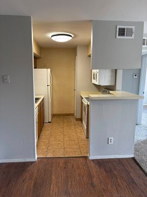 Springfield apartment for rent - A kitchen with a white refrigerator and wooden floors.