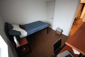 Hamilton apartment for rent - a small bedroom with a bed and a desk with a computer