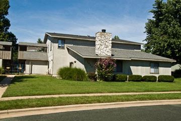 Springfield apartment for rent - a house with a stone chimney on the side of a street