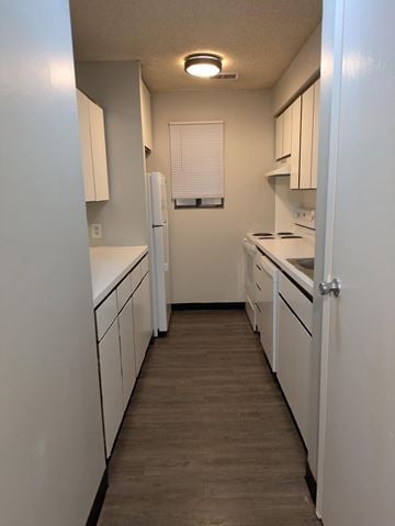 Springfield apartment for rent - A kitchen with white cabinets and a white refrigerator.