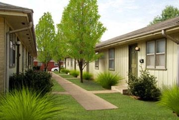 Springfield apartment for rent - a row of houses with green grass and trees