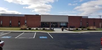 Ashland apartment for rent - A parking lot in front of a brick building.