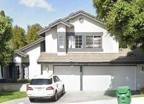 Carlsbad house for rent - A white house with a car parked in front.