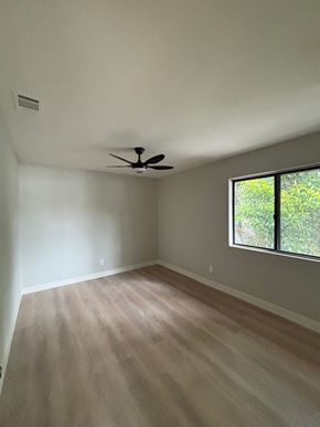 Carlsbad house for rent - A room with a ceiling fan and a window.