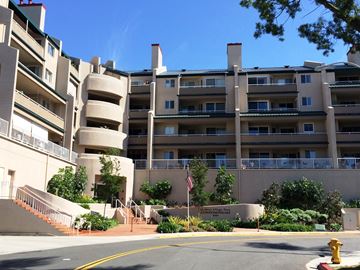 La Mesa apartment for rent - A large apartment complex with a flag on a pole in front.