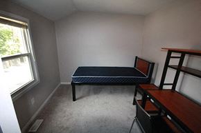 Hamilton apartment for rent - A bedroom with a bed, desk, and chair.