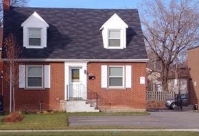 Hamilton apartment for rent - A red brick house with a black roof and white trim.