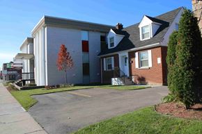Hamilton apartment for rent - A building with a red tree in front of it.