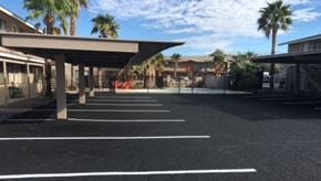 Bullhead City apartment for rent - A parking lot with a building in the background.