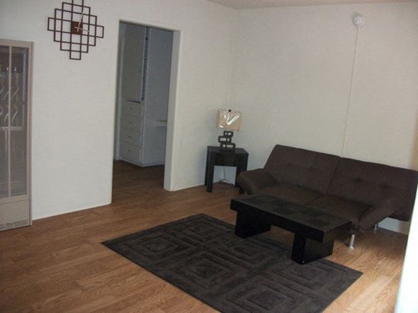Compton apartment for rent - a living room with a couch and a table