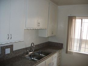Compton apartment for rent - a kitchen with a sink and white cabinets