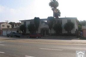 Compton apartment for rent - a building with palm trees and cars parked in front of it