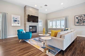 Mount Prospect apartment for rent - A living room with a blue chair and a grey couch.