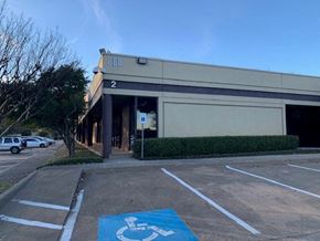 Richardson apartment for rent - a building with a handicapped sign in a parking lot