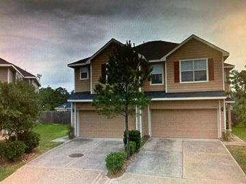 Humble house for rent - A house with a brown garage door and a driveway.