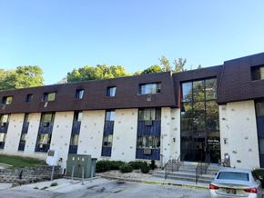 Wauwatosa apartment for rent - a large building with a car parked in front of it