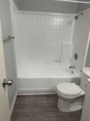 San Diego apartment for rent - A white bathroom with a toilet, tub, and shower.