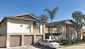 San Diego apartment for rent - A white car is parked in front of a house with a brown garage door.