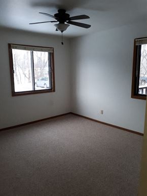 Sussex apartment for rent - A room with a ceiling fan and car visible through the window.