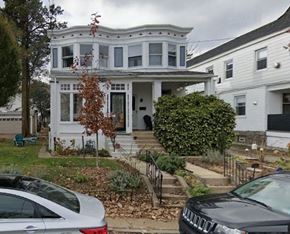 Narberth house for rent - A white two-story house with a porch and a tree in front.