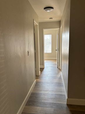 San Diego apartment for rent - A long hallway with a door at the end.