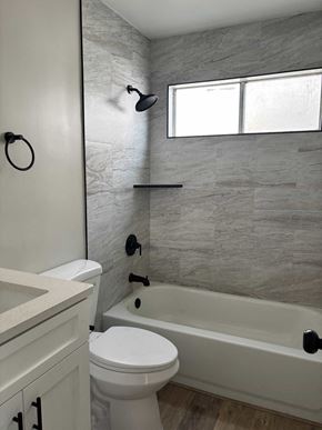 San Diego apartment for rent - A bathroom with a toilet, sink, and tub.