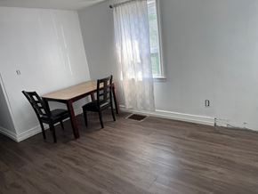 Hamilton apartment for rent - A dining room with a wooden table and chairs.
