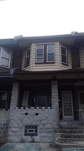 Philadelphia apartment for rent - A house with a stone pillar in front of it.