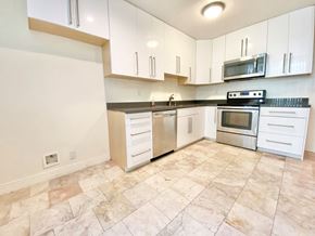 Los Angeles apartment for rent - an empty kitchen with white cabinets and stainless steel appliances
