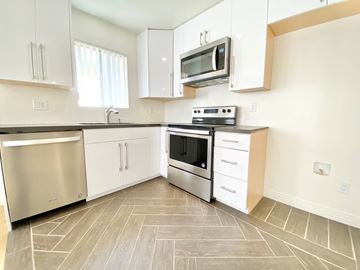 Los Angeles apartment for rent - a modern kitchen with stainless steel appliances and white cabinets