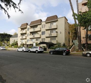 Los Angeles apartment for rent - a street with cars parked in front of an apartment building